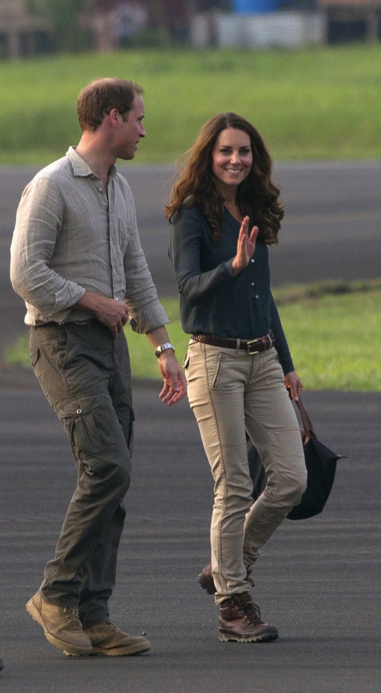 Image: Britain's Prince William and Catherine, Duchess of Cambridge wave farewell before leaving Lahad Datu airport, on the island of Borneo